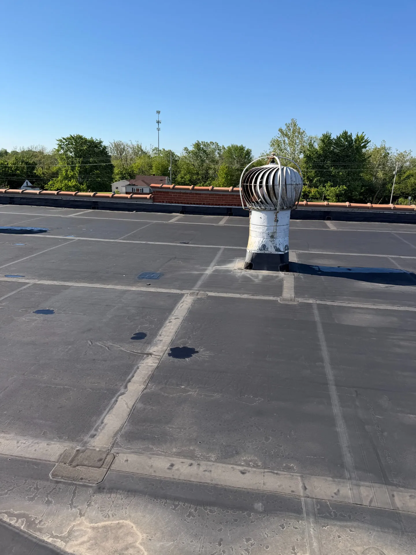 Close-up of an older commercial EPDM membrane with seams and surface wear