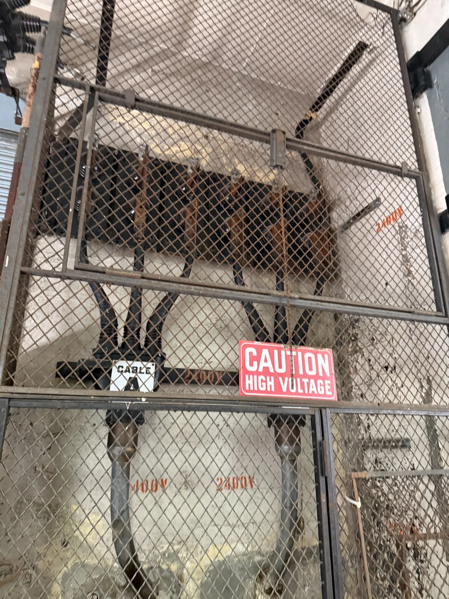 Industrial high-voltage electrical apparatus behind protective fencing at the WLW facility