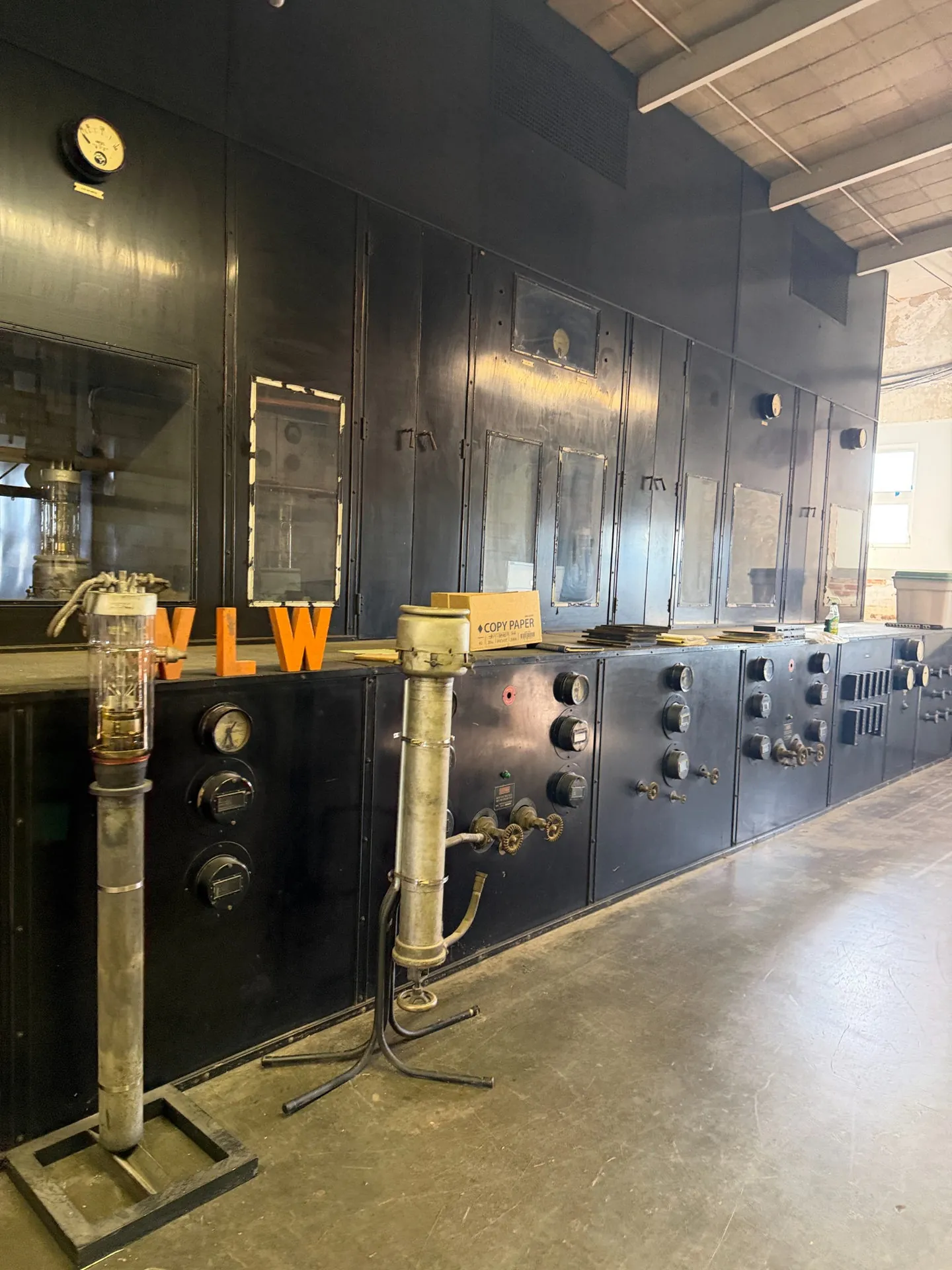 Tall black vintage WLW transmitter cabinets with windows, gauges and high-voltage components inside the Mason transmitter building